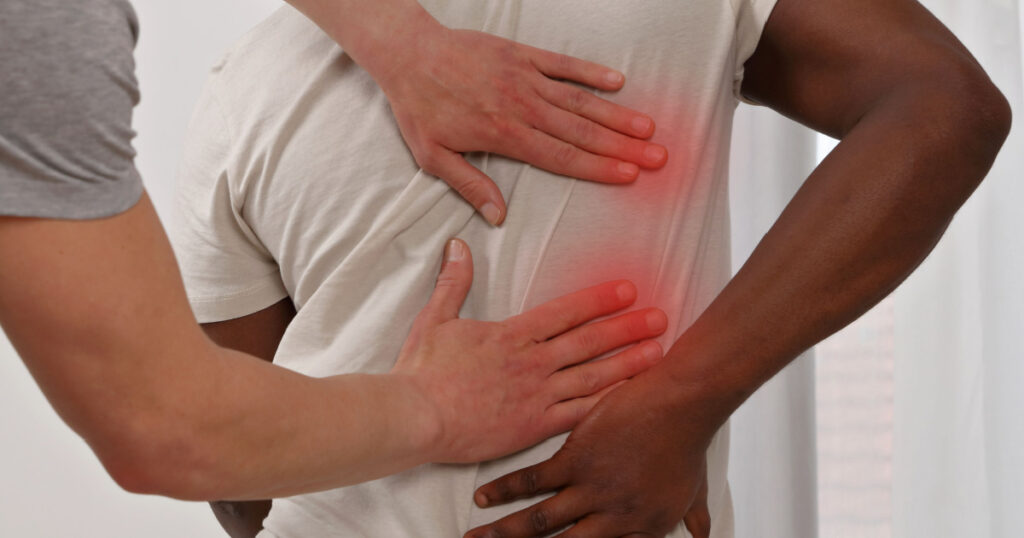 Man having Chiropractic Back Adjustment. Osteopathy, Physiotherapy, sport injury rehabilitation concept