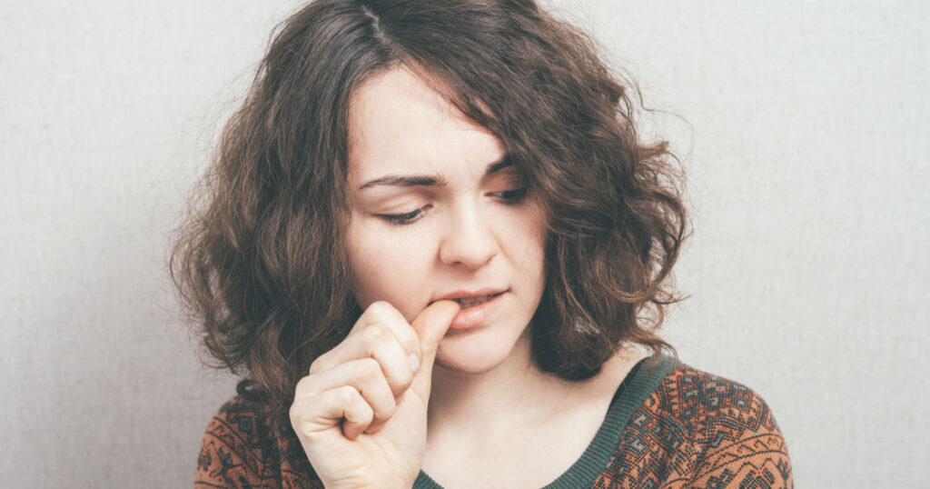 girl bites his nails