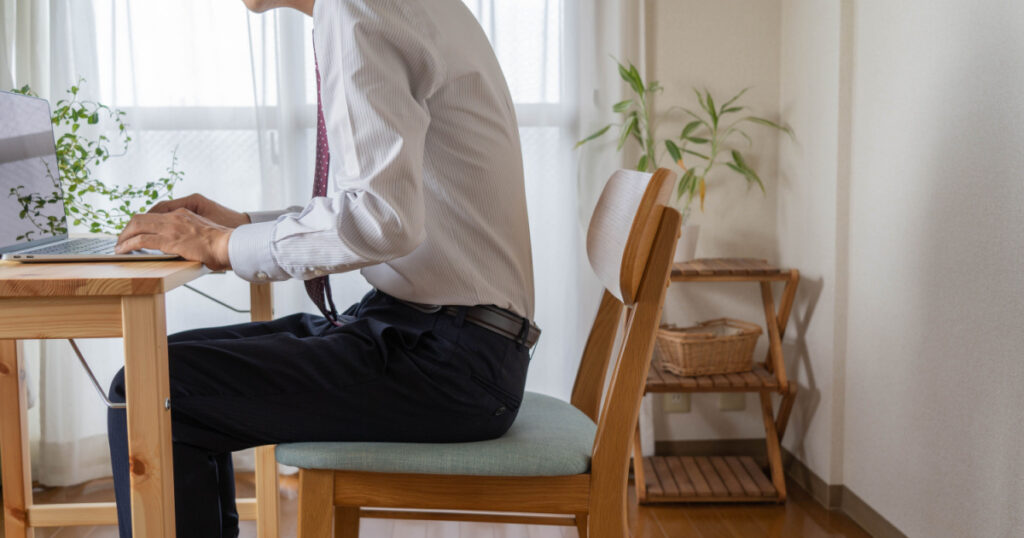 A man with a bad posture. He is a businessman who works at home.
