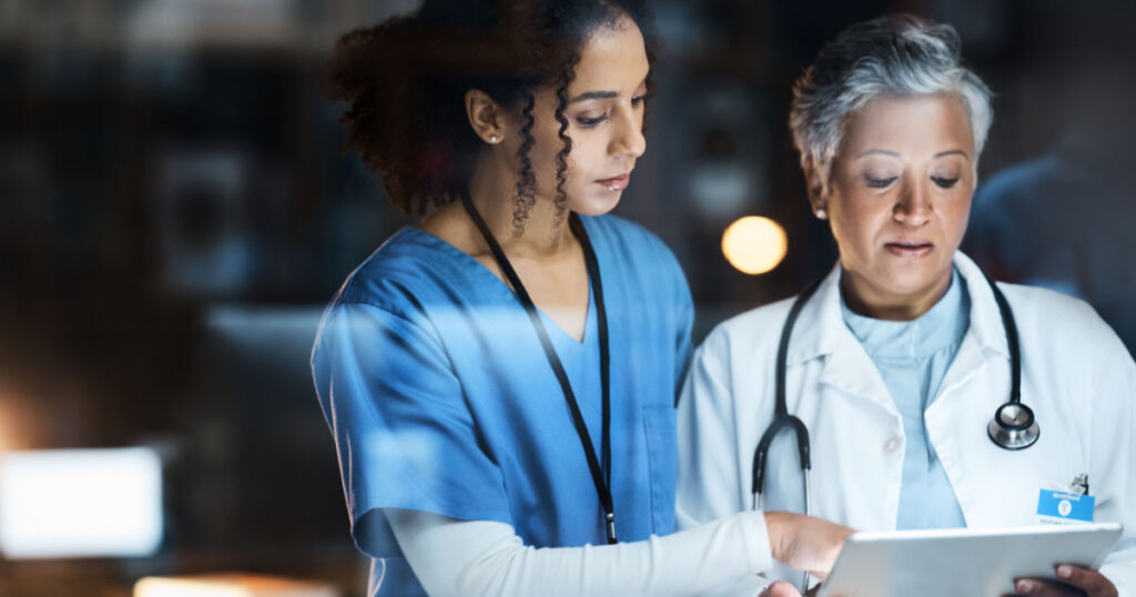 Women, doctors and tablet for night medical research, surgery planning and teamwork in hospital. Nurse, healthcare and worker collaboration on technology in late shift for wellness thinking and ideas
