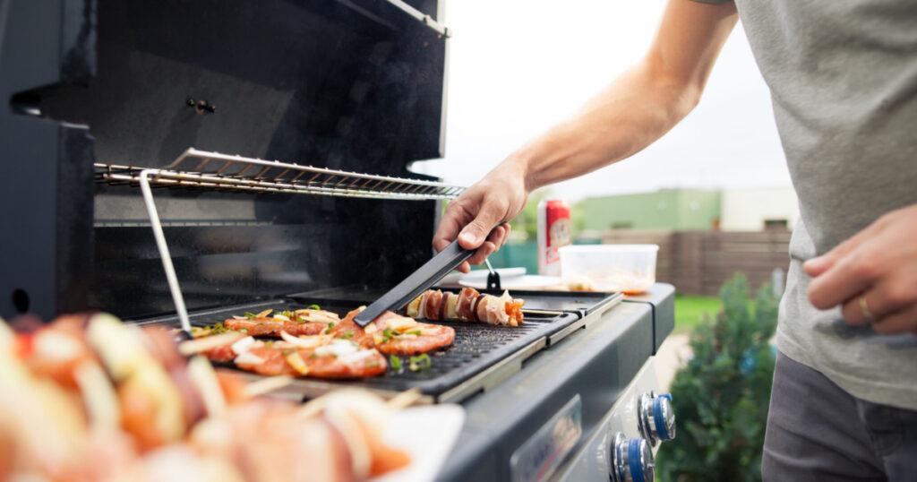 man BBQ'ing meat