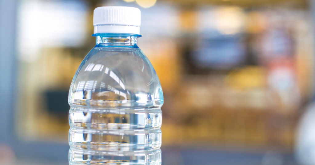 Bottle water made to plastic on the wood background.Using wallpaper for package or product, drug image and copy space.
