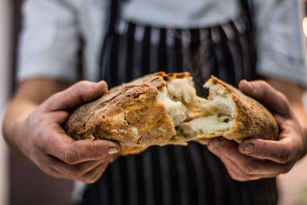 Chef Breaking Freshly Baked Sourdough Bread