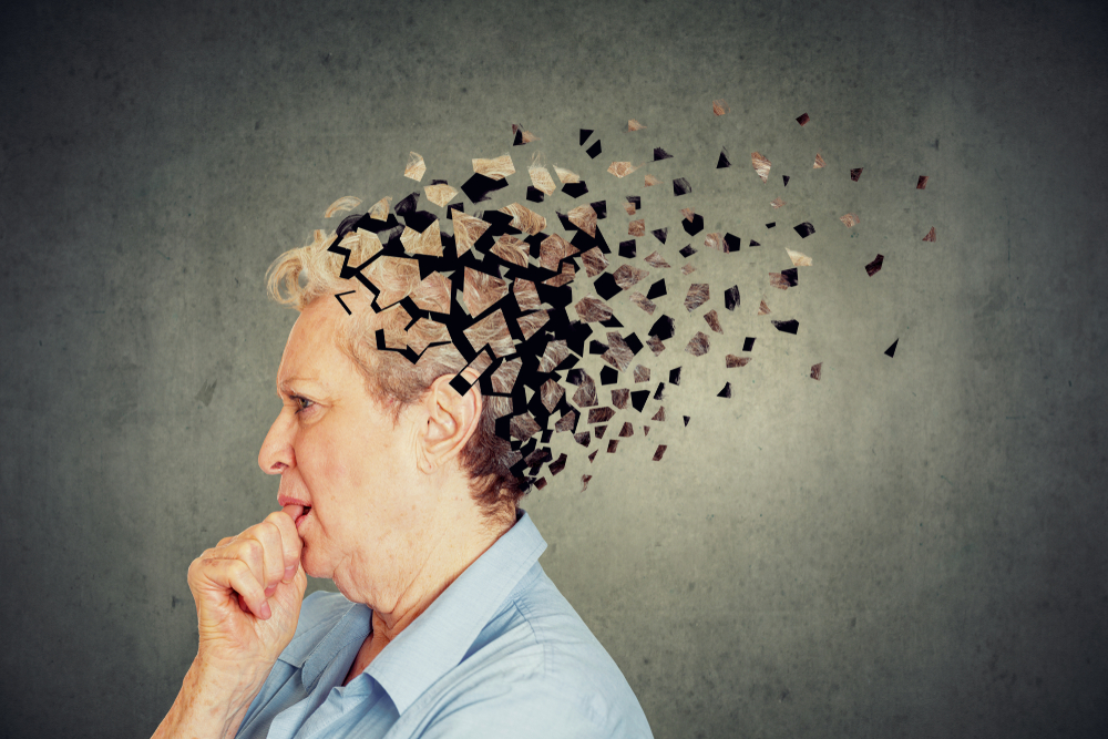 Memory loss due to dementia. Senior woman losing parts of head feeling confused as symbol of decreased mind function.