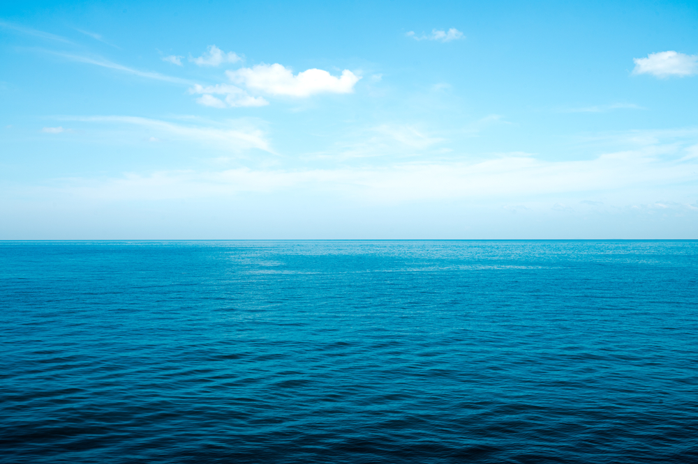The front view in the morning sky is bright blue with clear white clouds. And the ocean deep indigo in daylight. Feeling calm, cool, relaxing. The idea for cold background and copy space on the top.
