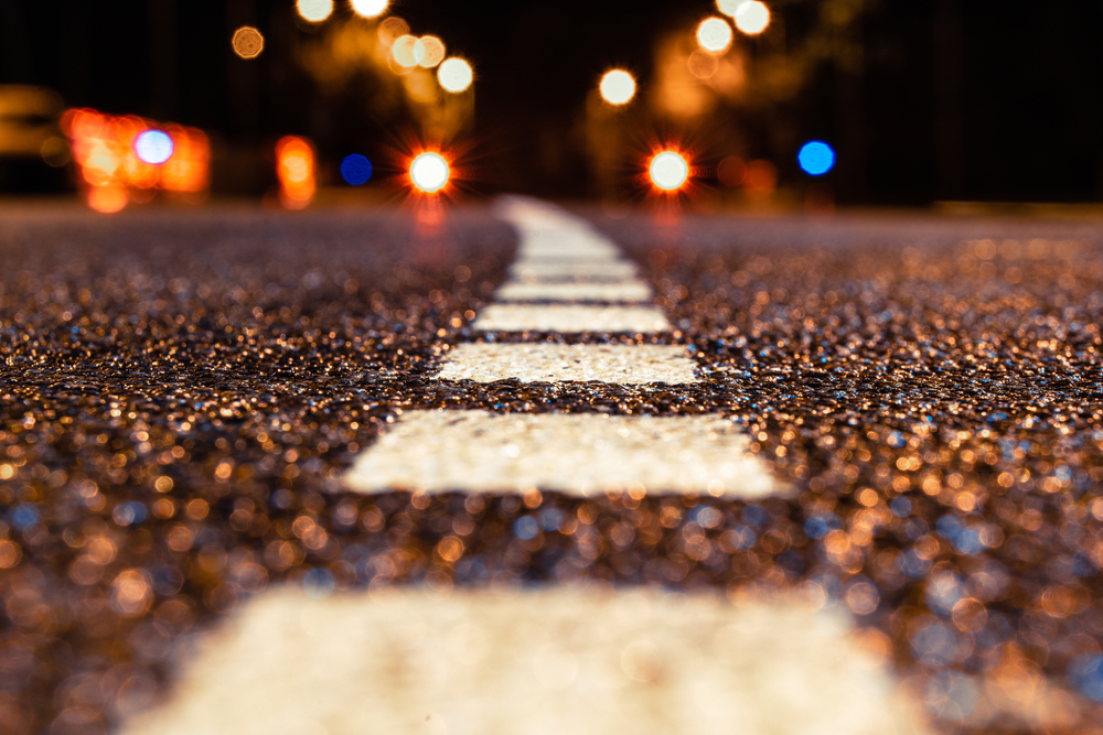 asphalt road leading into the city at night. Selective focus. background