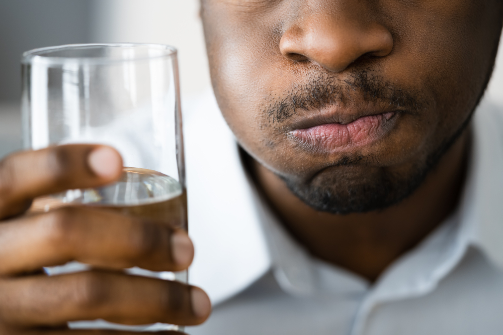 Water Mouth Gargle And Rinse. African American Man With Halitosis