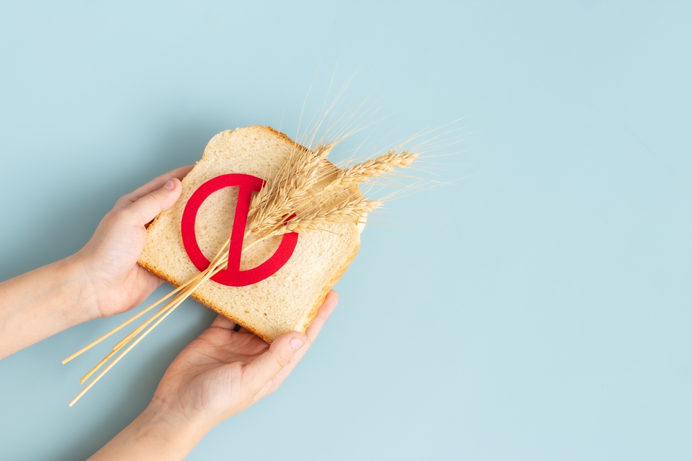 Hand holding a Bread slice marked with gluten free. celiac disease cover background
