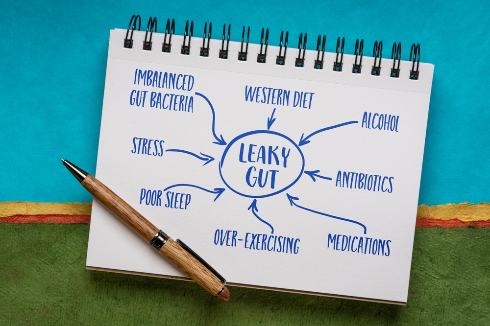 causes of leaky gut syndrome - text and drwaing in a sketchbook, digestive health concept