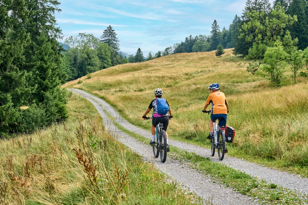 two senior girlfriends having fun during a cycling tour in the Allgau Alps near Oberstaufen, Bavaria, Germany