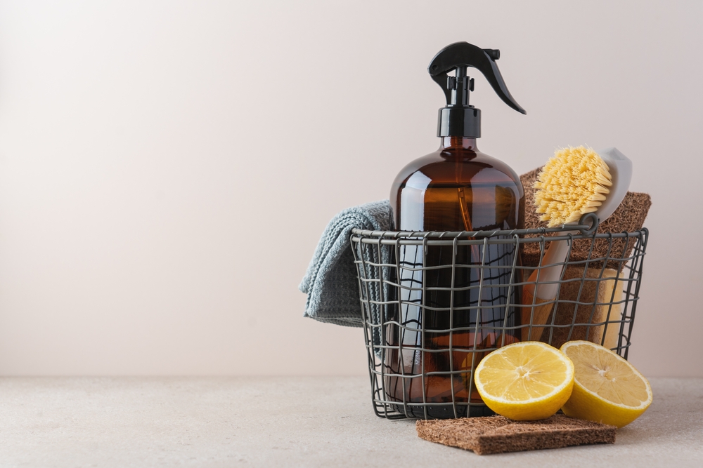 Zero waste cleaning supplies basket with spray glass bottle. Concept of natural cleaning products