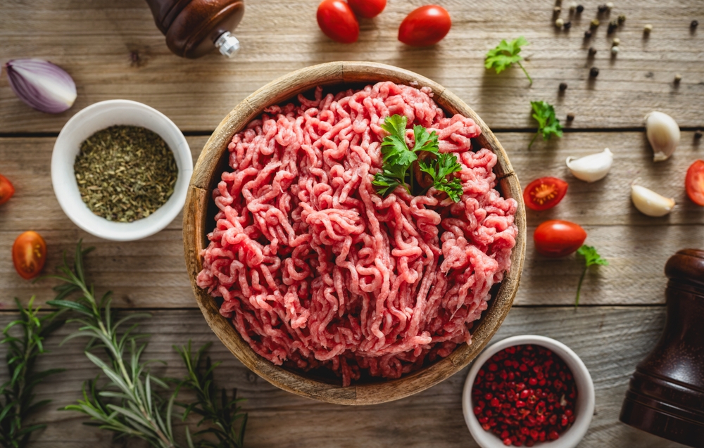 Fresh ground beef for cooking delicious and healthy food on wooden background top view