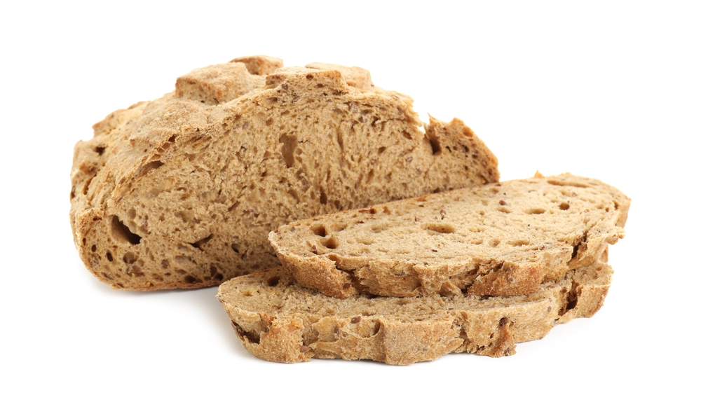 Freshly baked cut sourdough bread isolated on white