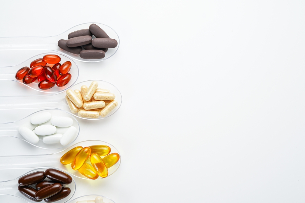 Various vitamin and mineral pills, food supplement health product in transparent spoon