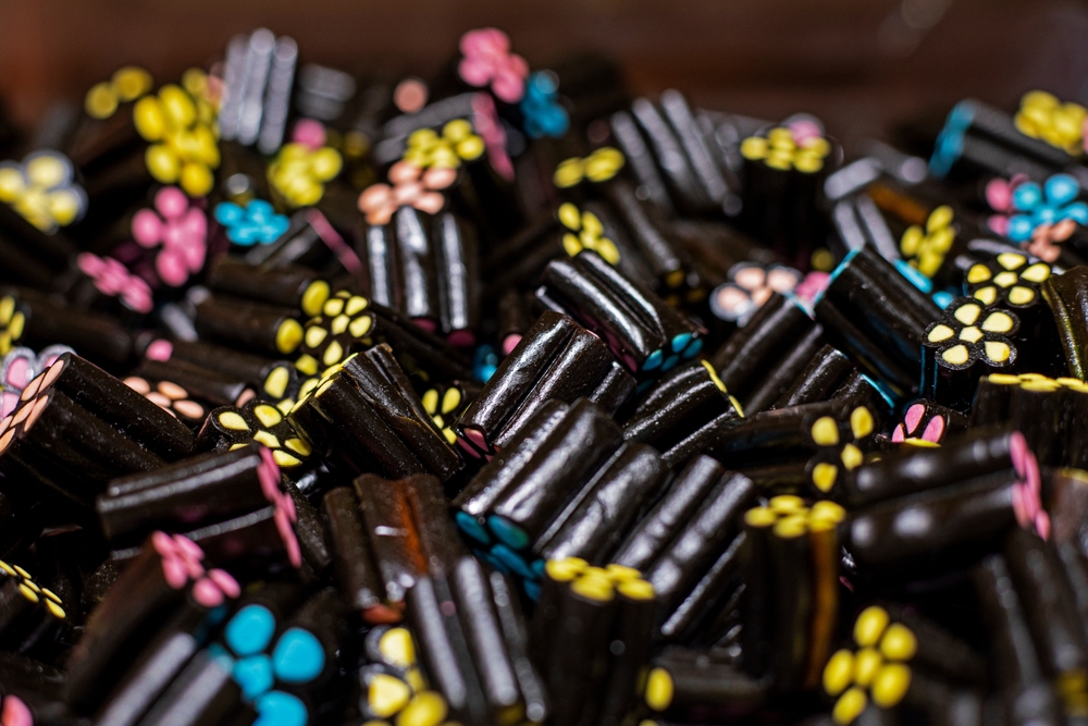 background of black chewing candies with licorice. medicinal sweets
