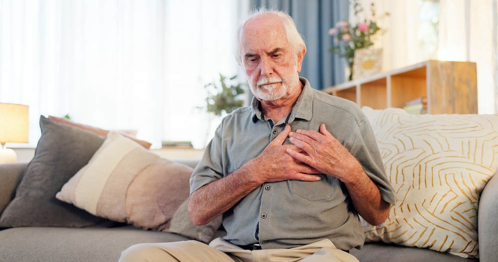 Old man, home and chest for heart attack or angina, pain and hypertension stress or lung fail. Elderly person, medical issue and cardiovascular disease or artery pressure, asthma and cardiac arrest