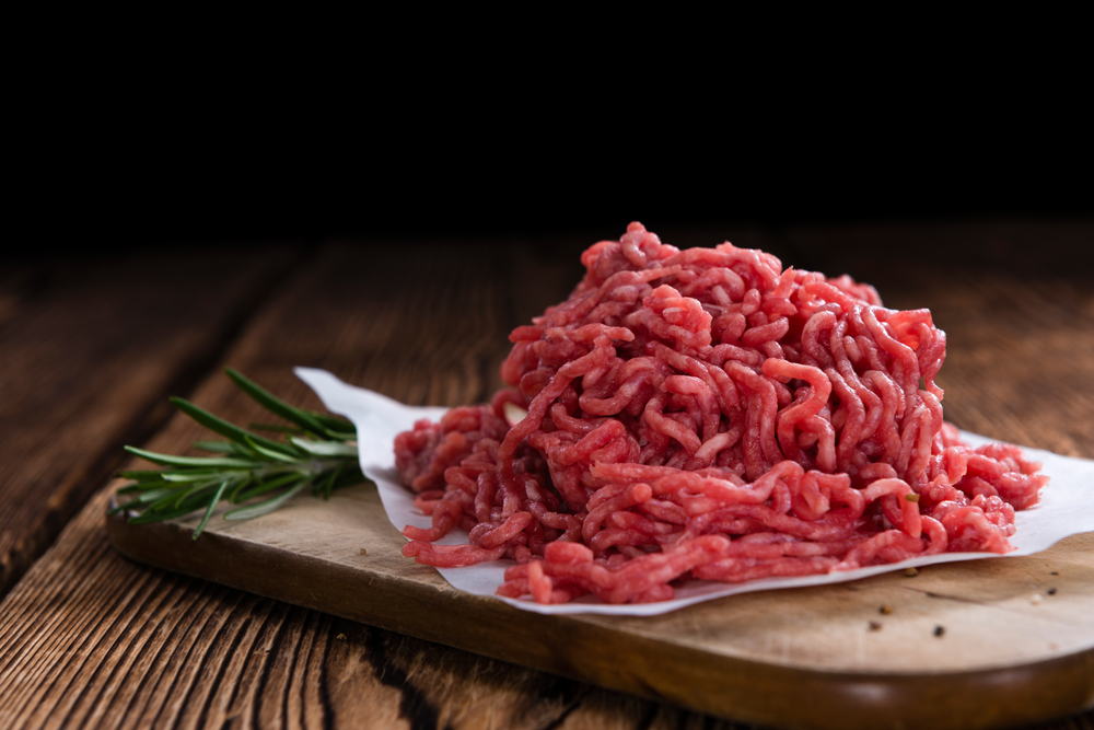 Minced Meat (Beef) as detailed close-up shot on dark wooden background