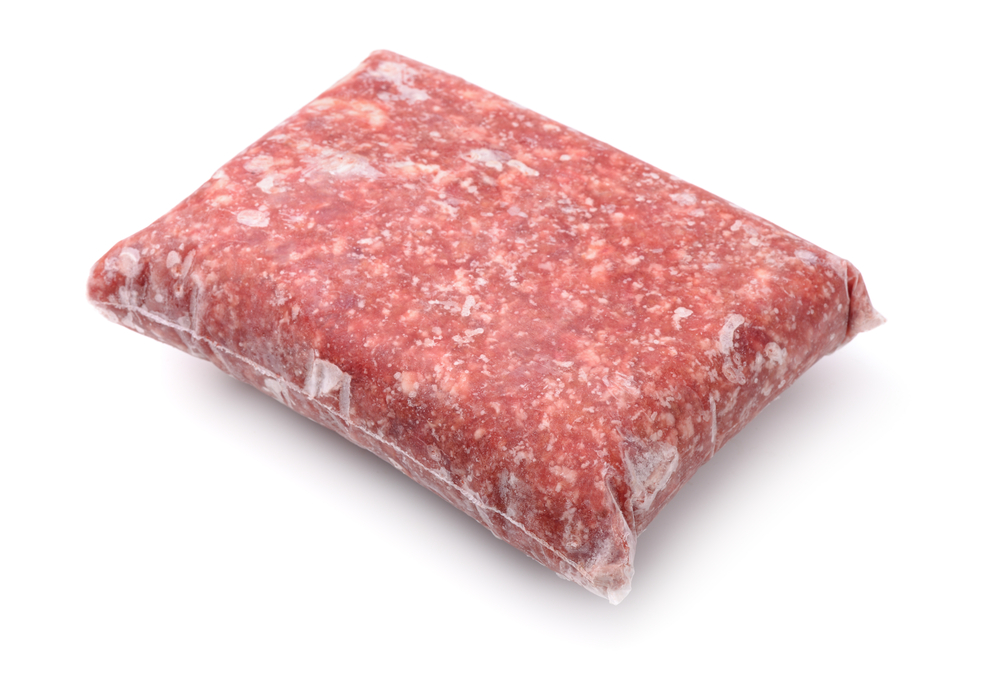 Pack of frozen ground meat isolated on white