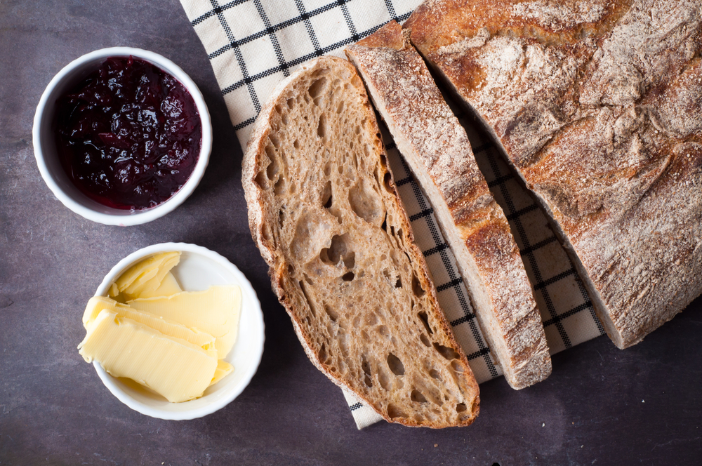Freshly baked cut sourdough bread isolated on white