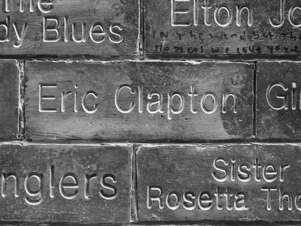 LIVERPOOL, UK - CIRCA JUNE 2016: The Wall of Fame at the Cavern Pub opposite the Cavern Club where The Beatles played. Detail of the Eric Clapton tile. in black and white
