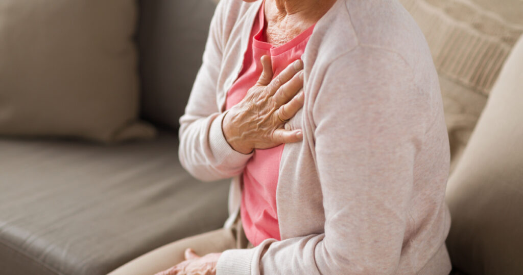 old age, health problem and people concept - close up of senior woman suffering from heartache at home
