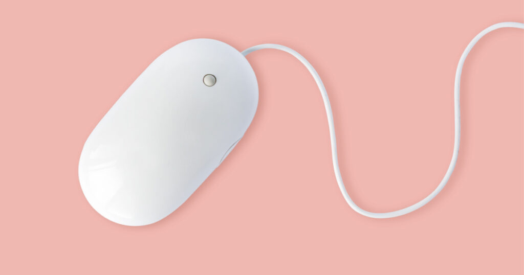 Simple white computer mouse with cord isolated on pastel pink background, minimal style
