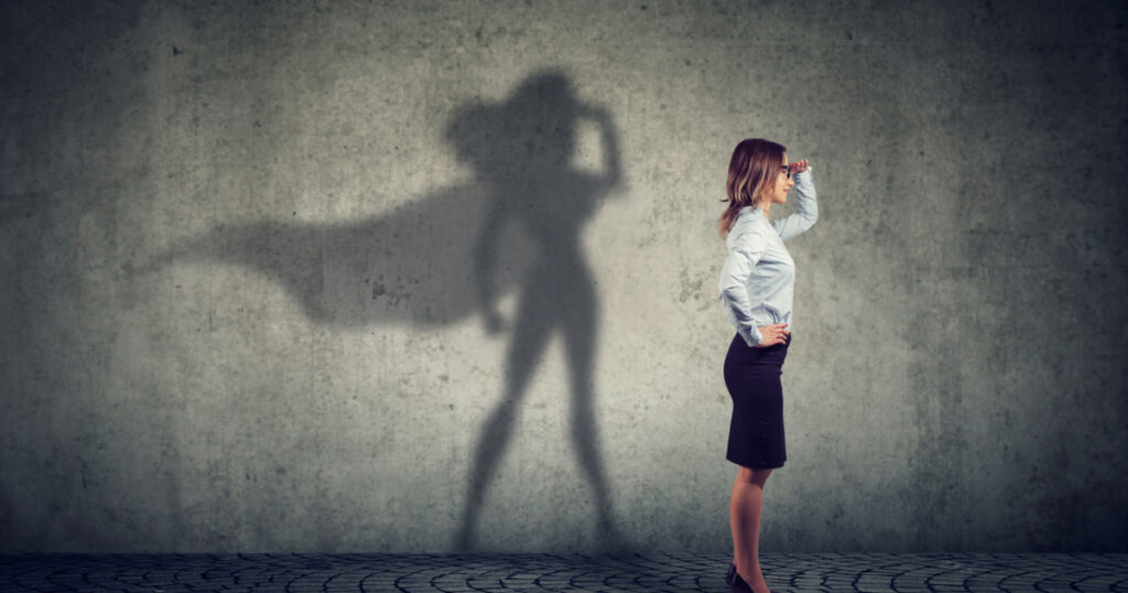 Side view of a business woman imagining to be a super hero looking aspired.