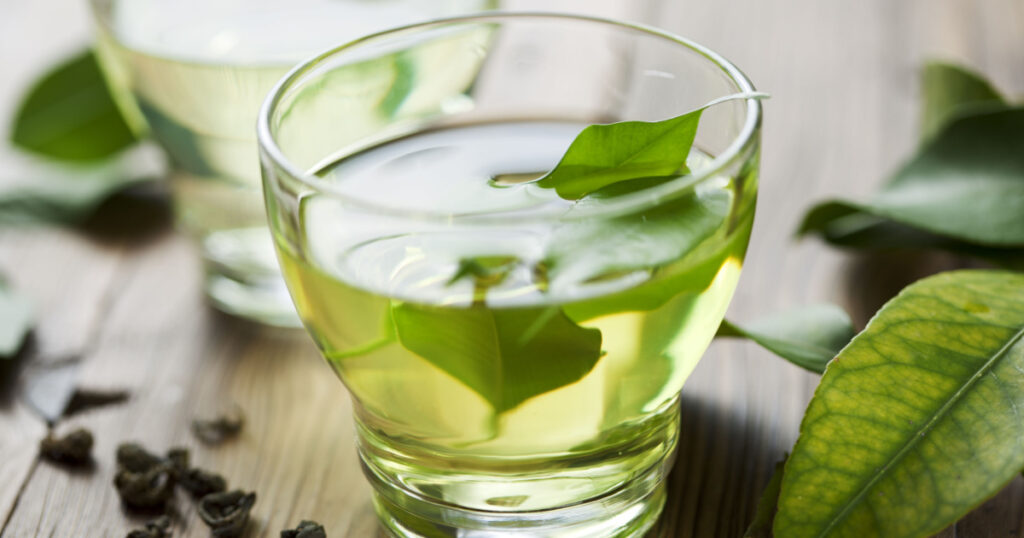 glass cup with fresh green tea