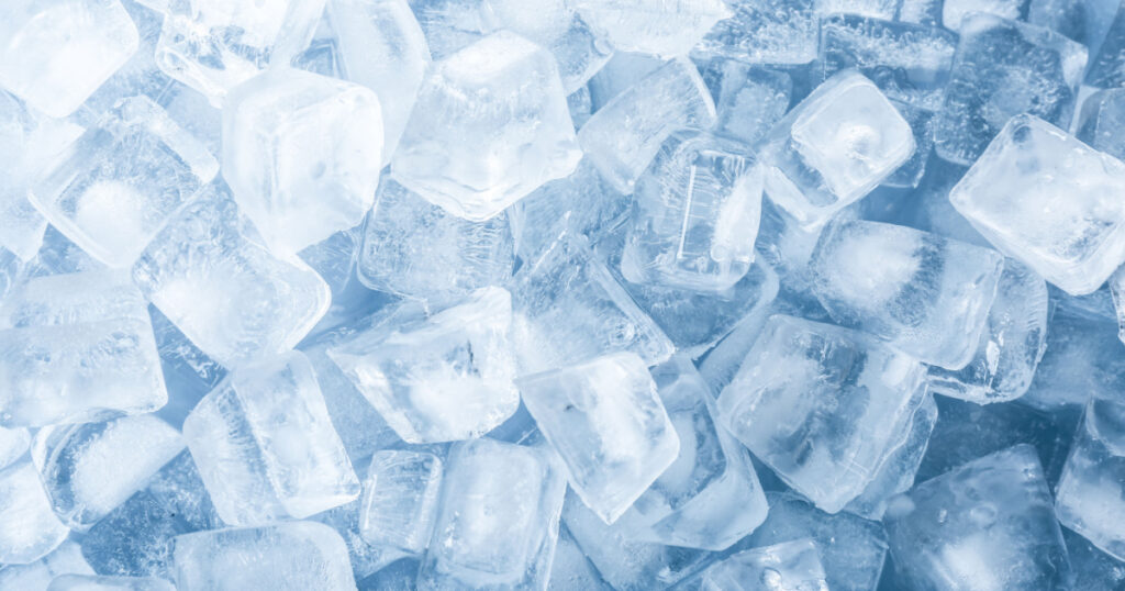 Crystal clear ice cubes as background, top view