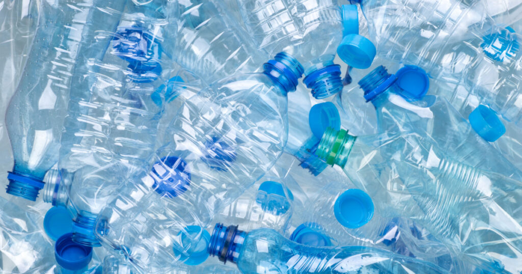 Plenty of plastic bottles on white background top view