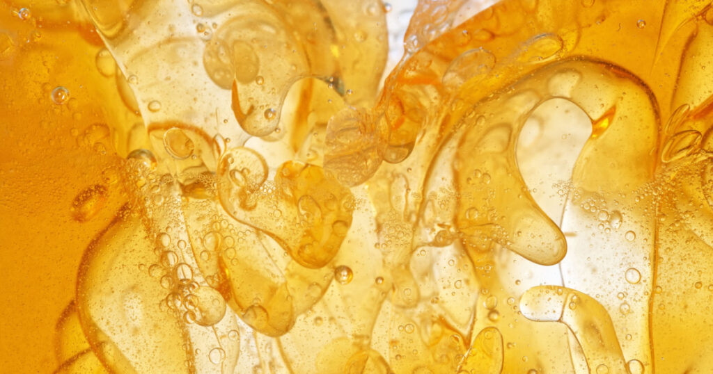Yellow fat, like obesity cells, under the microscope, is a chemical process of atoms and molecules. Close-up.