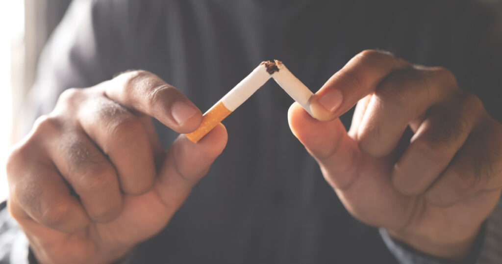 Man refusing cigarettes concept for quitting smoking and healthy lifestyle dark background. or No smoking campaign Concept.
