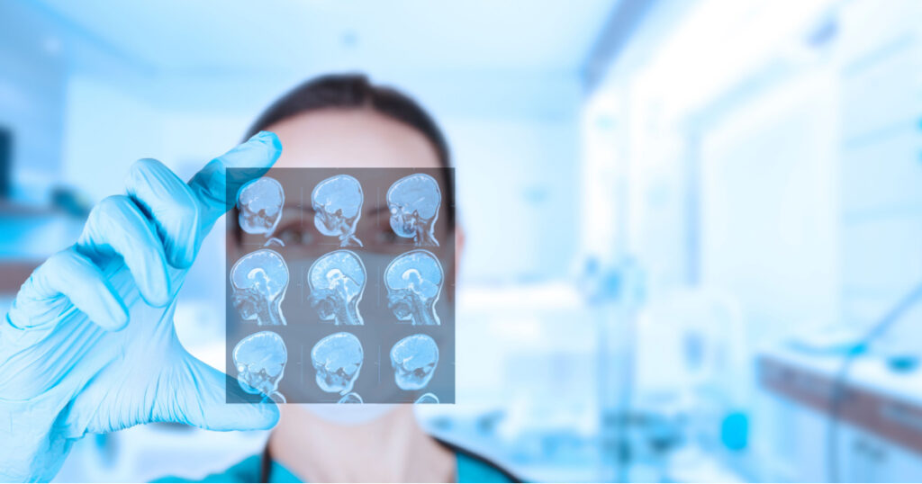 Beautiful woman doctor radiologist, oncologist looks at MRI images of a child. Soft blurred clinic background. kids vaccine