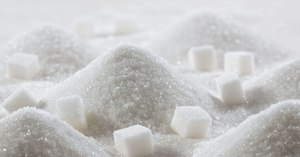 White granulated sugar and refined sugar cubes close-up