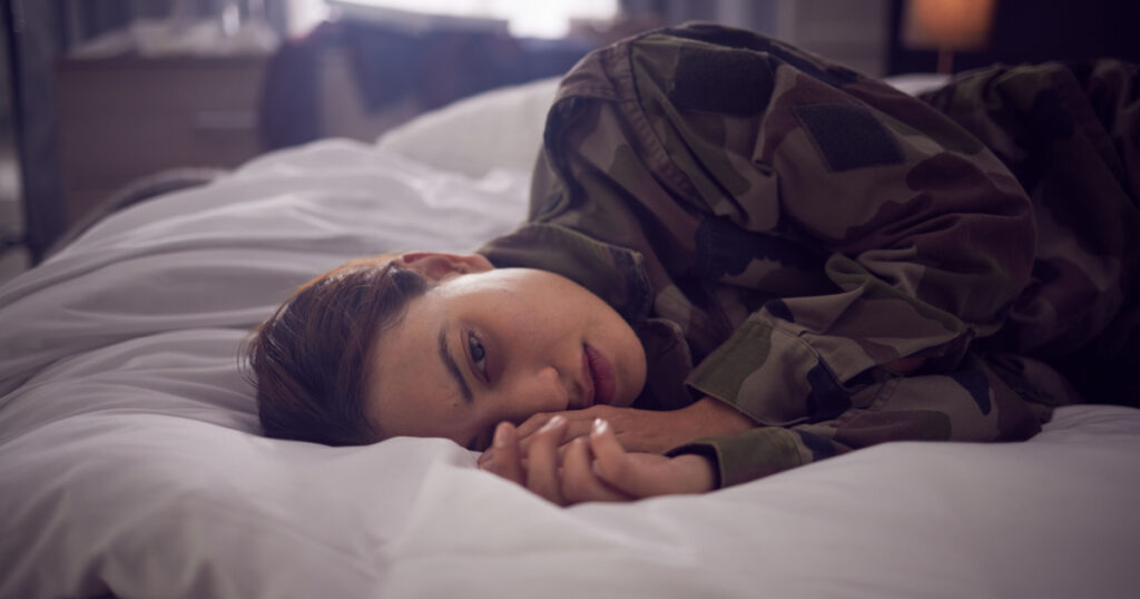 Thinking, tired and depression of a woman with mental health, anxiety or insomnia problem. Fatigue, stress and sad person in a bedroom bed feeling depressed ready for sleep on a house pillow