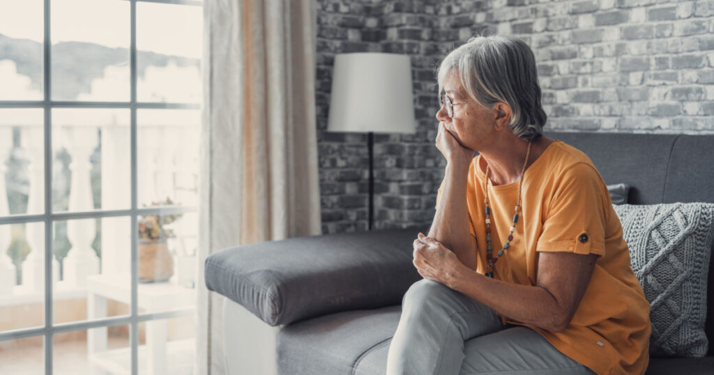 Face of senior caucasian hoary woman looking away deep in sad thoughts feels lonely close up portrait, recollect memories and life moments, depressed grandmother alone indoors, yearning for husband
