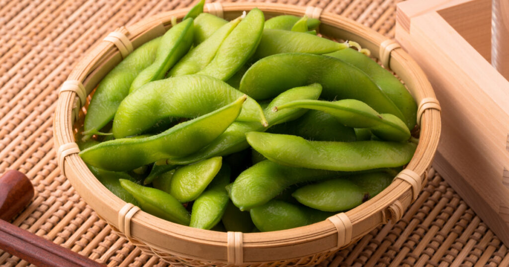An image of edamame and sake.