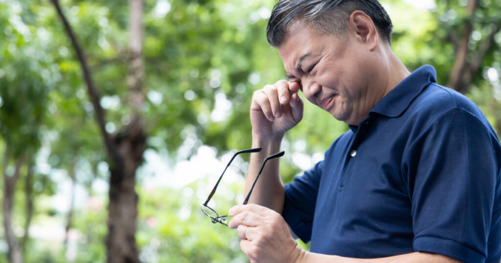 Senior Asian Man holding unfit glasses, Struggling with Eyesight Problem, Eye Health Concept
