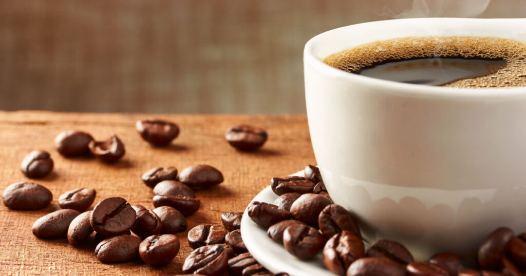 Coffee cup and coffee beans on table