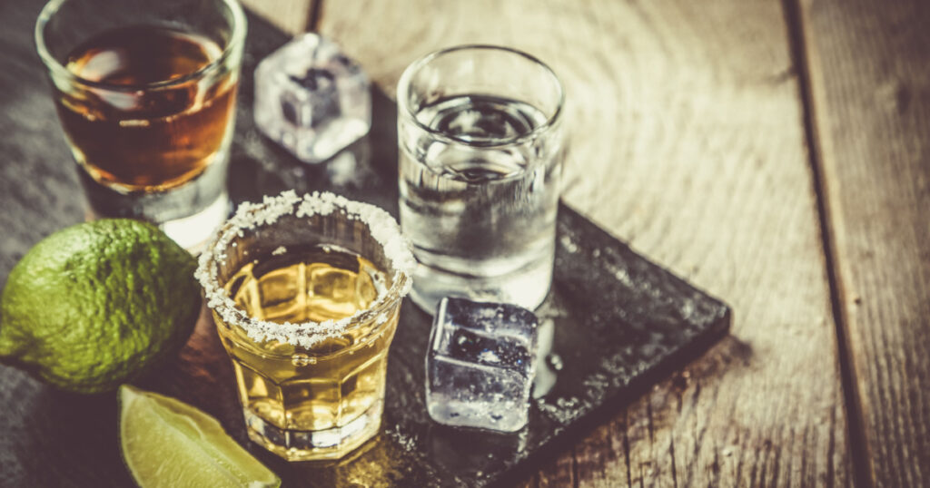 Selection of alcoholic drinks on rustic wood background