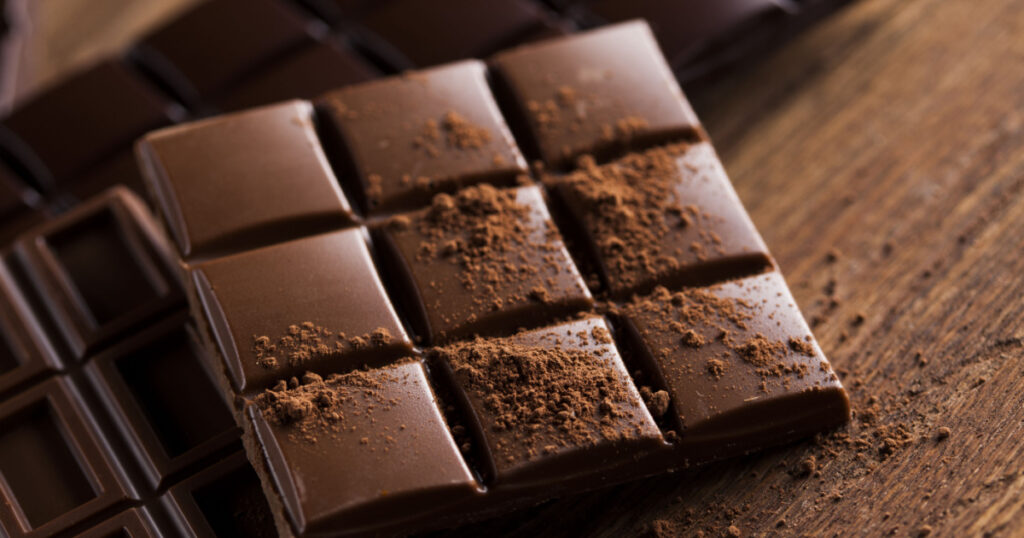 Milk and dark chocolate on a wooden table