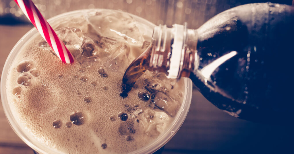 Refreshing Bubbly Soda Pop with Ice Cubes. Cold soda iced drink in a glasses - Selective focus, shallow DOF.
