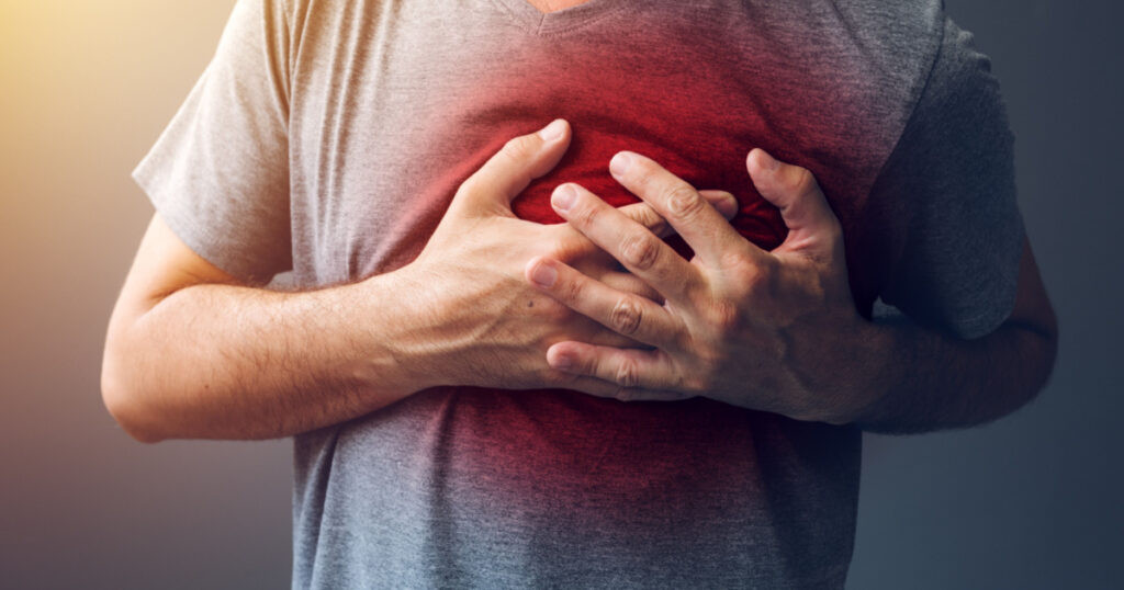 Adult male with heart attack or heart burn condition, health and medicine concept
