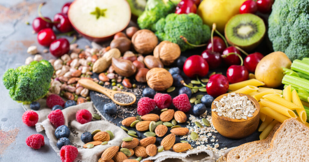 Healthy balanced dieting concept. Selection of rich fiber sources vegan food. Vegetables fruit seeds beans ingredients for cooking