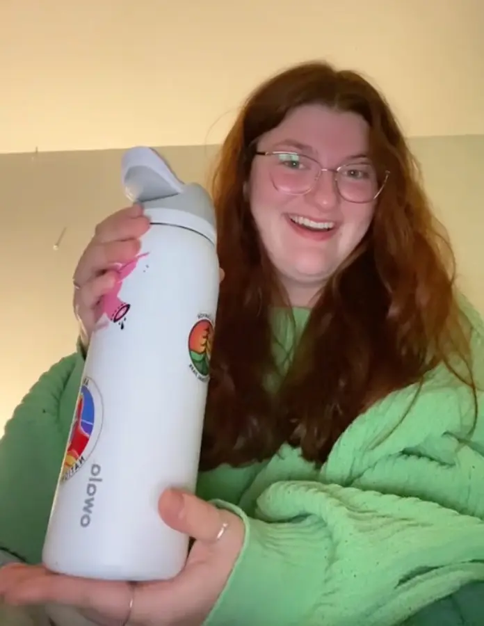Woman holding water bottle