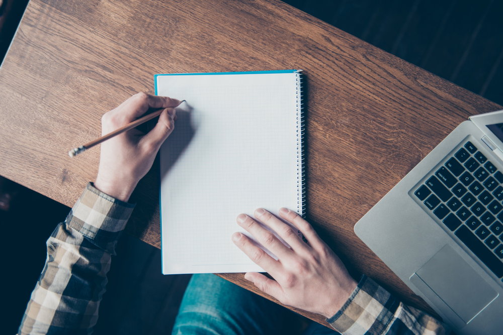 Paint painter sketch learn office workstation workplace letter notes feedback book idea report script classroom message home memo remark concept. Top view photo of left-handed man making notes in book
