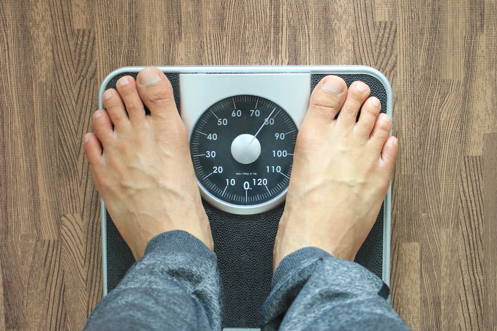 Male on the weight scale for check weight, Diet concept
