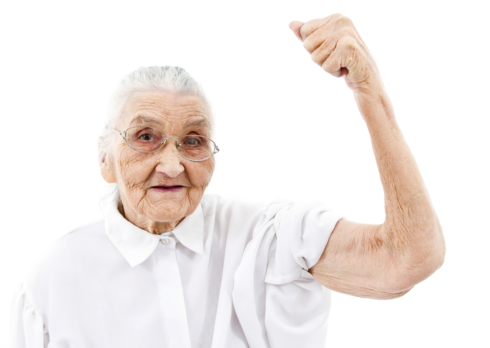 very old woman showing her muscles on her arms
