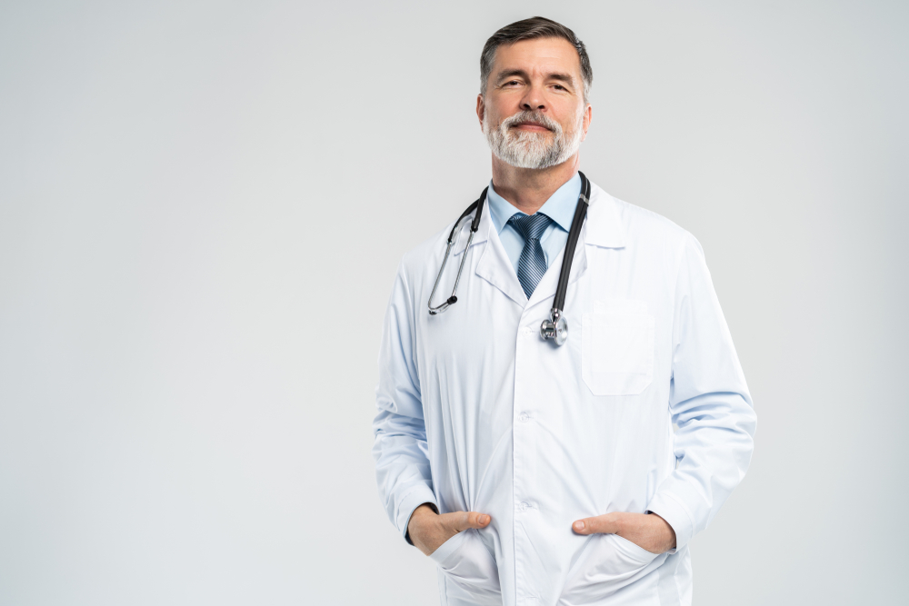 Cheerful mature doctor posing and smiling at camera, healthcare and medicine
