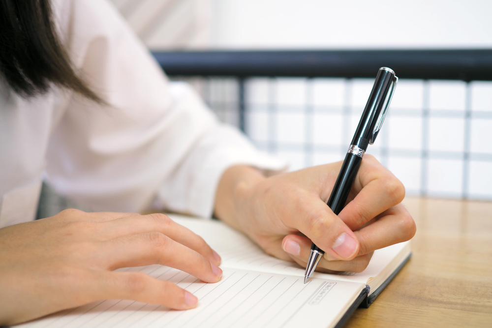 The woman's hand is written using the left hand.